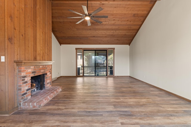 unfurnished living room with baseboards, wood ceiling, a fireplace, wood finished floors, and a ceiling fan