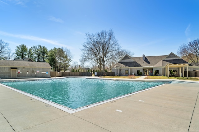 community pool featuring a patio area and fence