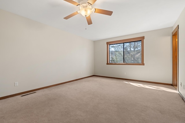interior space with light carpet, visible vents, ceiling fan, and baseboards