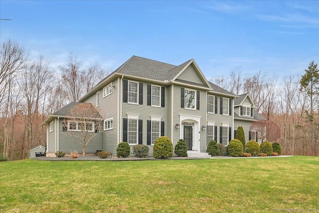 colonial-style house with a front yard
