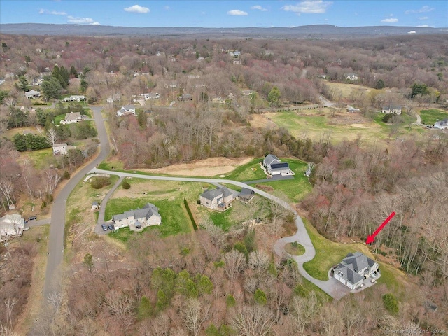 drone / aerial view with a wooded view