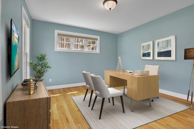 office space featuring baseboards and wood finished floors