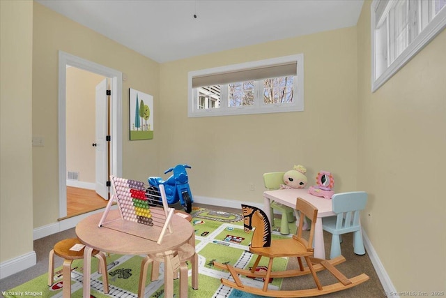 game room with baseboards, visible vents, and plenty of natural light