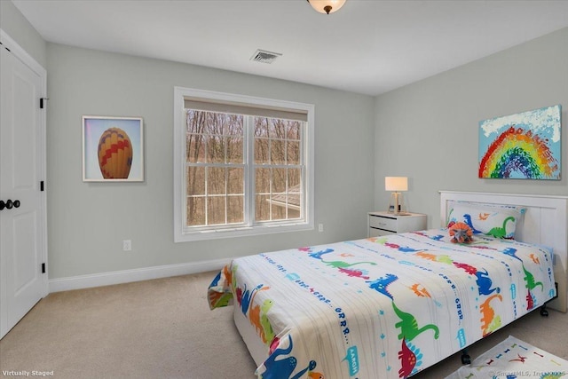 carpeted bedroom with baseboards and visible vents