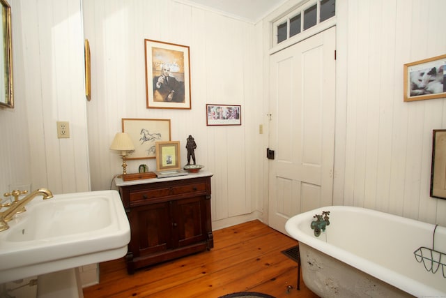 11 Hodge Rd, Roxbury, CT 06783 - bathroom featuring hardwood / wood-style flooring, a freestanding tub, and a sink