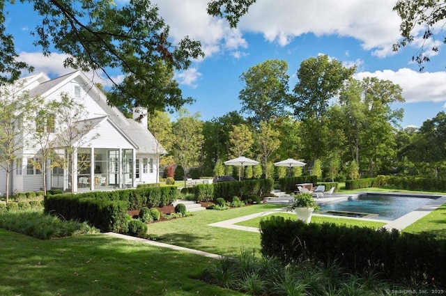 view of grassy yard with an outdoor pool