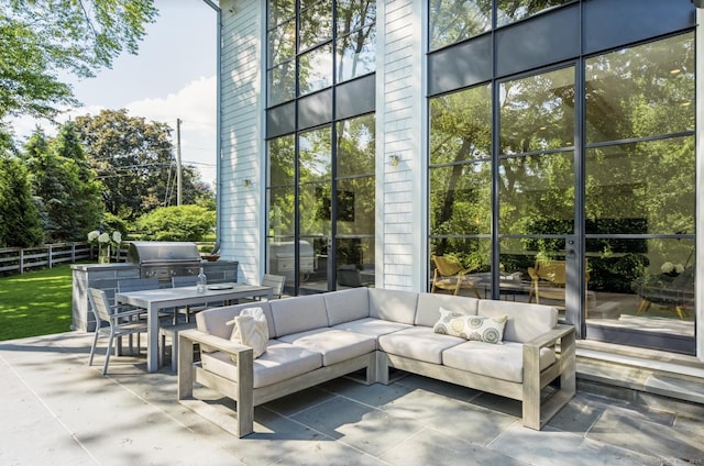 view of patio featuring area for grilling, outdoor lounge area, outdoor dining space, and fence