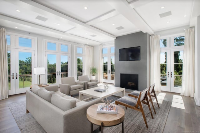 living room featuring french doors, wood finished floors, a fireplace, beamed ceiling, and coffered ceiling