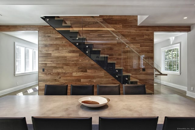 bar area featuring baseboards, stairway, and wood finished floors