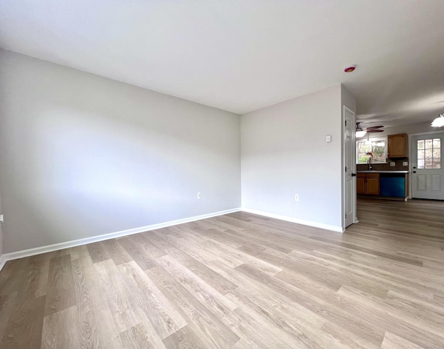 200 Yale St Unit 15B, Waterbury, CT 06704 - unfurnished room featuring light wood-style flooring, a ceiling fan, baseboards, and a sink
