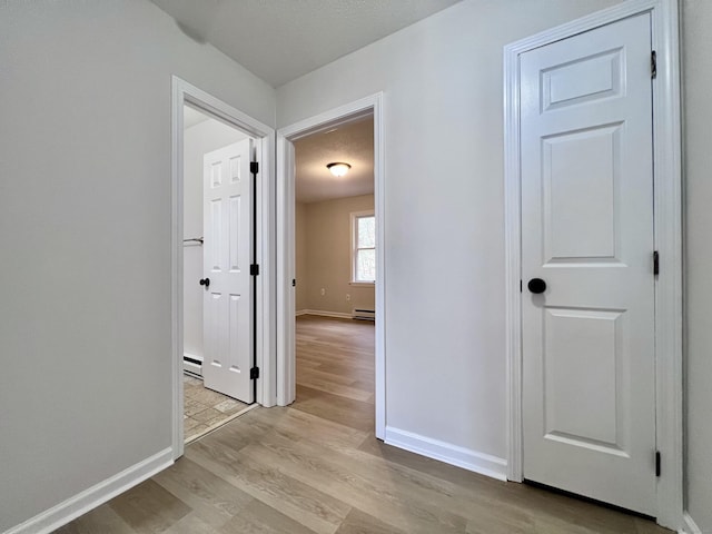 200 Yale St Unit 15B, Waterbury, CT 06704 - hallway with baseboards, light wood-type flooring, and baseboard heating