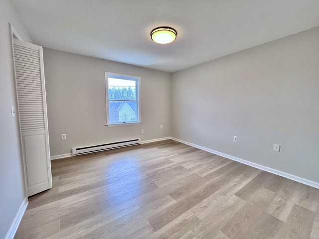 200 Yale St Unit 15B, Waterbury, CT 06704 - unfurnished bedroom featuring light wood-style flooring, a baseboard heating unit, and baseboards