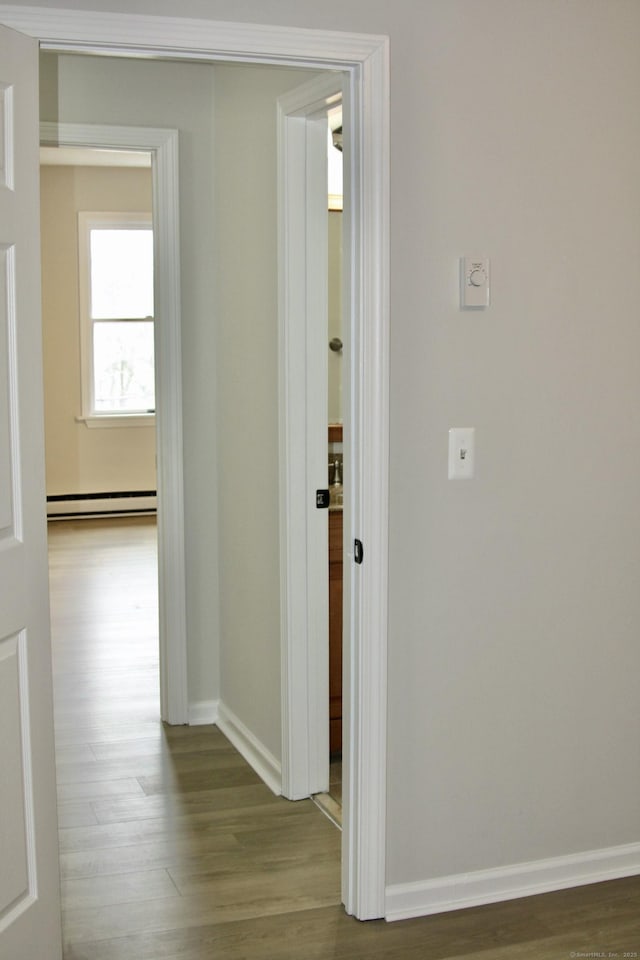 200 Yale St Unit 15B, Waterbury, CT 06704 - hallway featuring a baseboard radiator, baseboards, and wood finished floors
