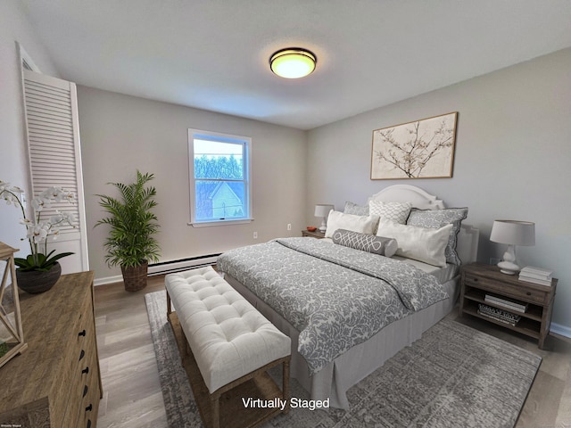 200 Yale St Unit 15B, Waterbury, CT 06704 - bedroom with baseboard heating, baseboards, and wood finished floors