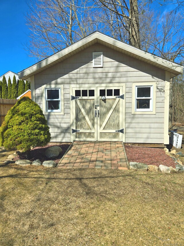 view of outbuilding featuring an outbuilding and fence
