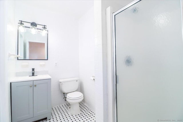25 Jefferson Dr, New Milford, CT 06776 - bathroom with tile patterned floors, a stall shower, vanity, tile walls, and toilet