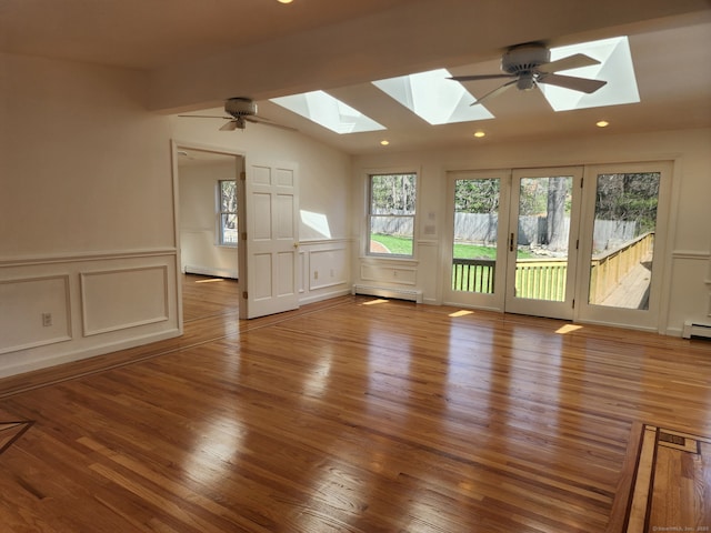 25 Jefferson Dr, New Milford, CT 06776 - unfurnished room featuring baseboard heating, a decorative wall, a wealth of natural light, and a skylight