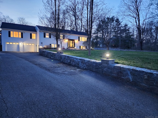25 Jefferson Dr, New Milford, CT 06776 - split foyer home featuring an attached garage, a front lawn, and aphalt driveway