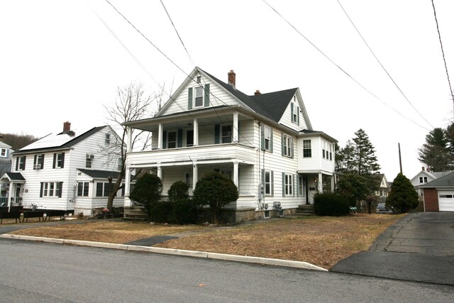 view of front facade featuring a porch and a chimney