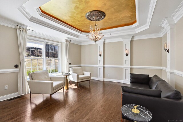250 Valley Stream Ln, Southbury, CT 06488 - sitting room with a raised ceiling, dark wood-type flooring, decorative columns, ornamental molding, and a chandelier