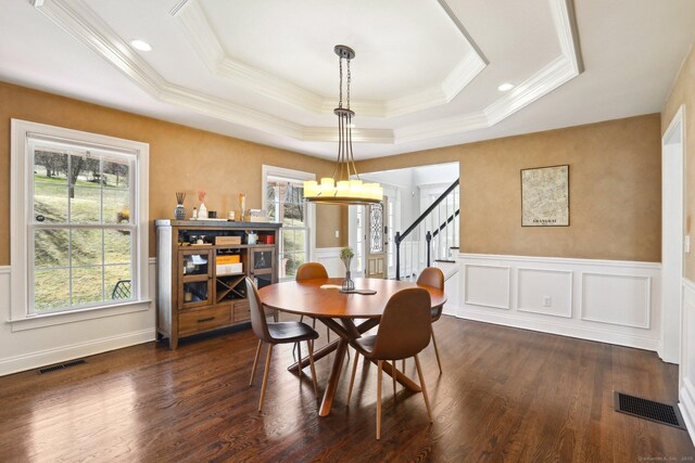 250 Valley Stream Ln, Southbury, CT 06488 - dining area with ornamental molding, stairway, a raised ceiling, a decorative wall, and dark wood-style floors