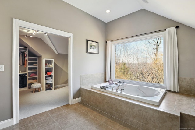 250 Valley Stream Ln, Southbury, CT 06488 - bathroom featuring vaulted ceiling, tile patterned floors, a tub with jets, a spacious closet, and baseboards