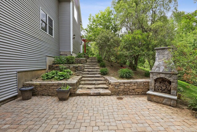250 Valley Stream Ln, Southbury, CT 06488 - view of patio / terrace with an outdoor stone fireplace
