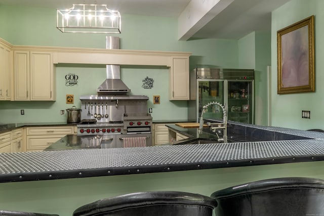 8 Tom Rd, East Haddam, CT 06423 - kitchen with cream cabinets, dark countertops, paneled built in fridge, and stainless steel range