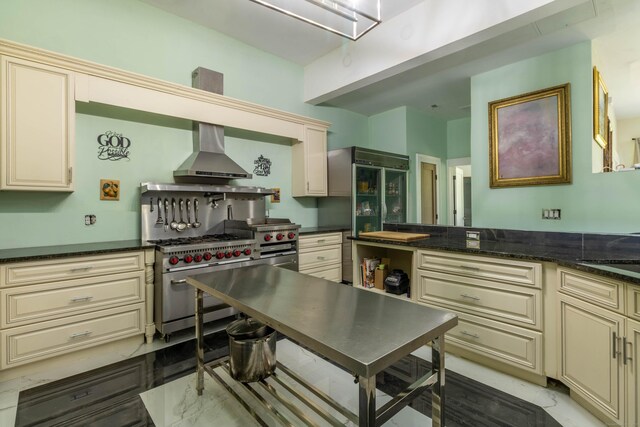 8 Tom Rd, East Haddam, CT 06423 - kitchen featuring cream cabinetry, double oven range, wall chimney exhaust hood, and dark stone countertops