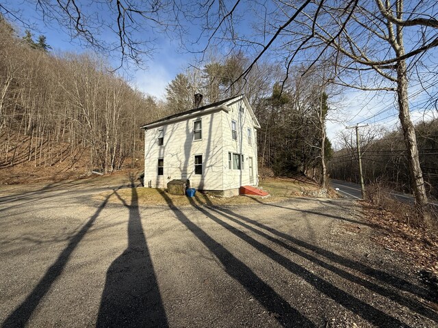 226 Greenwoods Rd W, Norfolk, CT 06058 - view of side of property with gravel driveway and a chimney