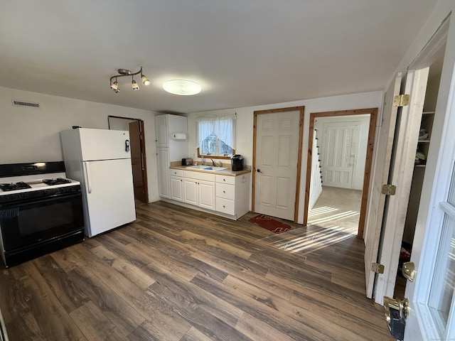 226 Greenwoods Rd W, Norfolk, CT 06058 - kitchen with visible vents, gas range oven, freestanding refrigerator, dark wood-style floors, and a sink