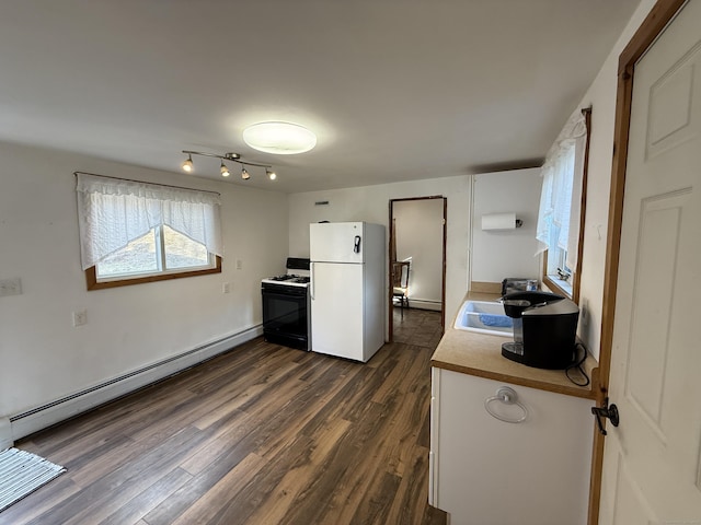 226 Greenwoods Rd W, Norfolk, CT 06058 - kitchen with dark wood finished floors, baseboard heating, range with gas stovetop, freestanding refrigerator, and a sink