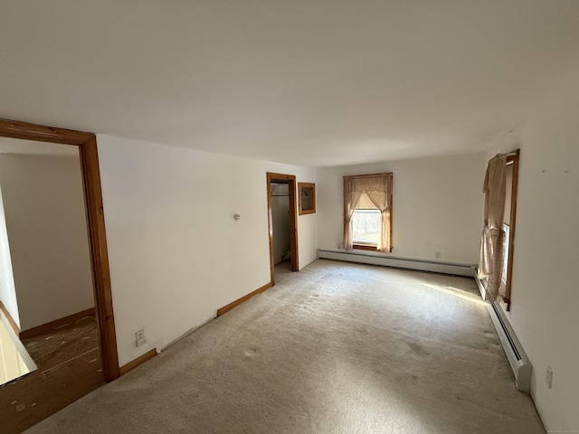 226 Greenwoods Rd W, Norfolk, CT 06058 - spare room featuring a baseboard heating unit, baseboards, and light colored carpet