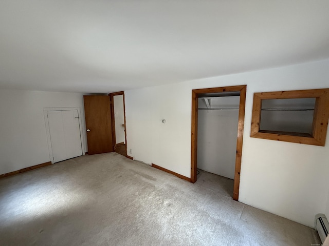 226 Greenwoods Rd W, Norfolk, CT 06058 - unfurnished bedroom featuring a closet, baseboard heating, and light colored carpet