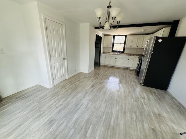 19 Huntington Rd, Scotland, CT 06264 - kitchen featuring freestanding refrigerator, light wood-type flooring, a chandelier, baseboards, and a sink