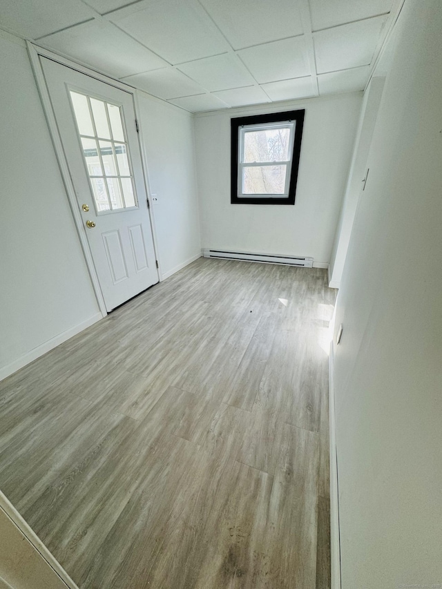 19 Huntington Rd, Scotland, CT 06264 - unfurnished room featuring a baseboard heating unit, a drop ceiling, wood finished floors, and baseboards
