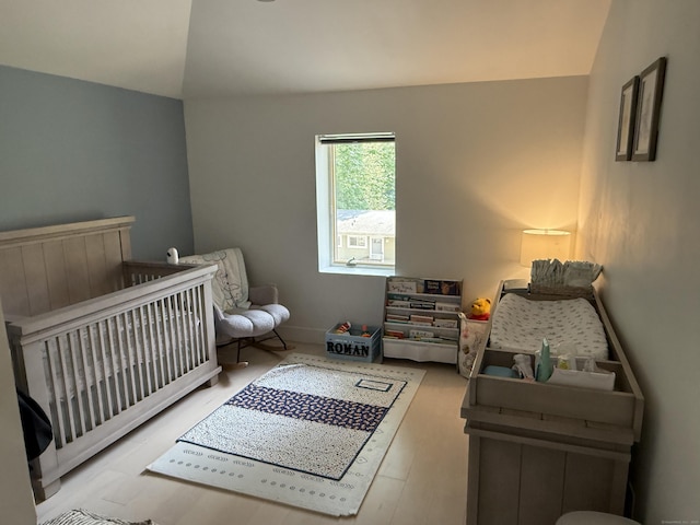 8 Hubbard Rd, North Branford, CT 06471 - bedroom with lofted ceiling, a nursery area, baseboards, and wood finished floors