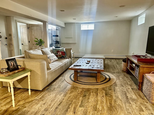 living room featuring a baseboard radiator and wood finished floors
