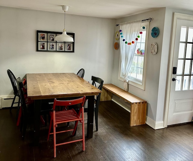 dining room featuring dark wood finished floors and baseboards