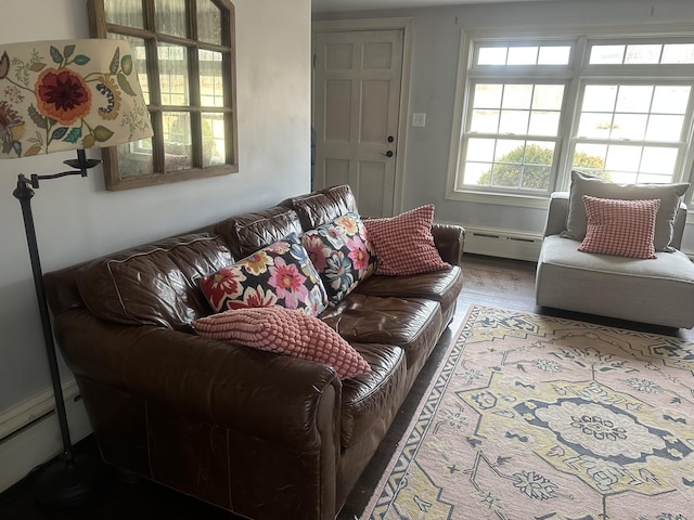 living area with a baseboard heating unit and wood finished floors