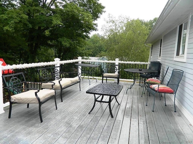wooden terrace with outdoor dining area