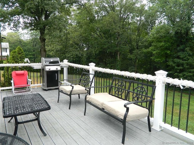 wooden deck featuring a grill