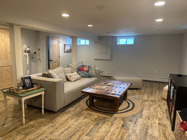 living area with a baseboard radiator, wood finished floors, and recessed lighting