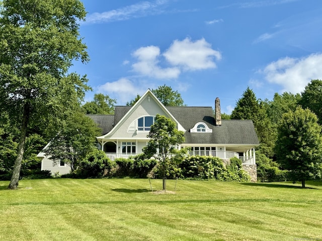 view of front facade with a front lawn and a chimney