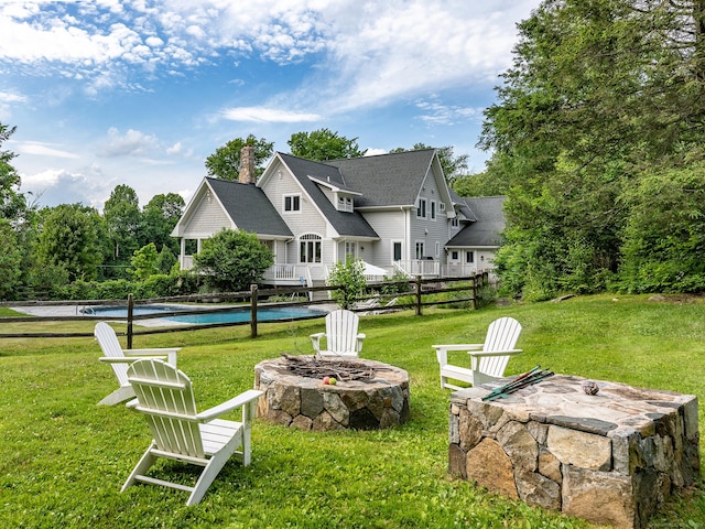 view of yard with a fire pit and a fenced in pool