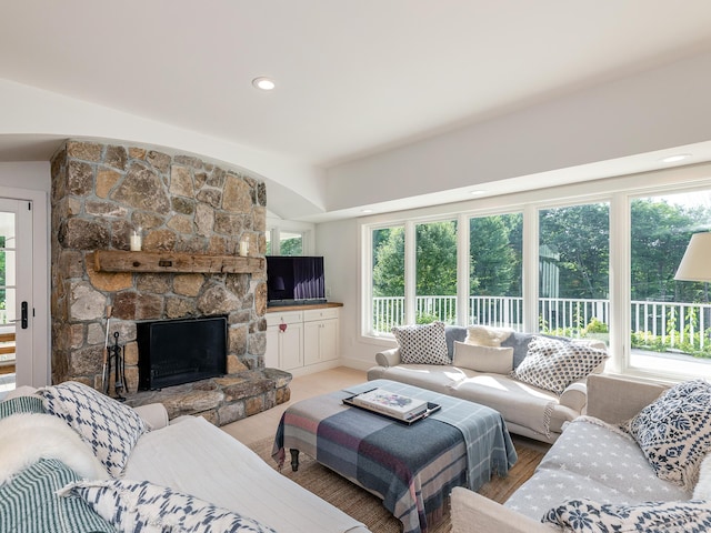 living room featuring recessed lighting and a stone fireplace