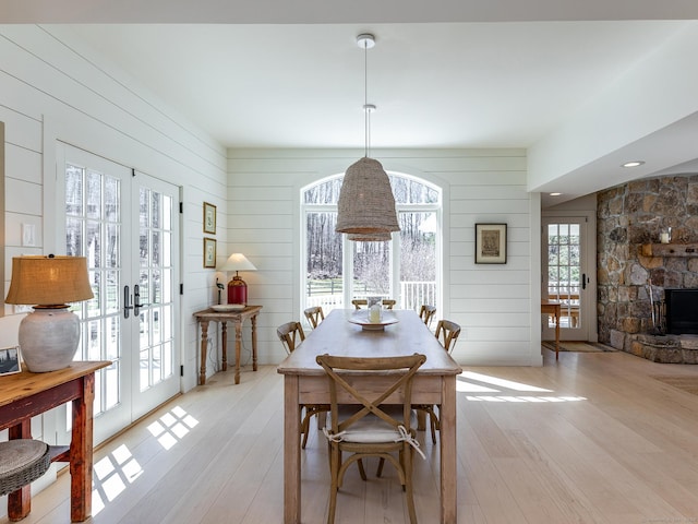 dining space featuring a wealth of natural light, french doors, and light wood-style flooring