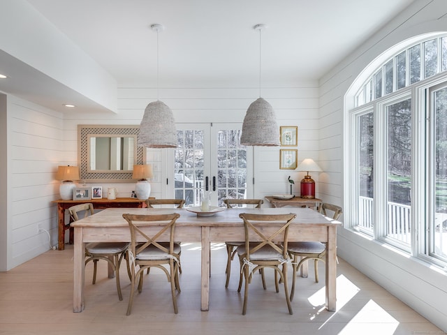 dining space with french doors and light wood-type flooring
