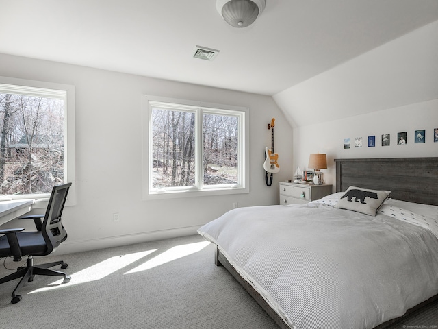 carpeted bedroom with visible vents, baseboards, and vaulted ceiling
