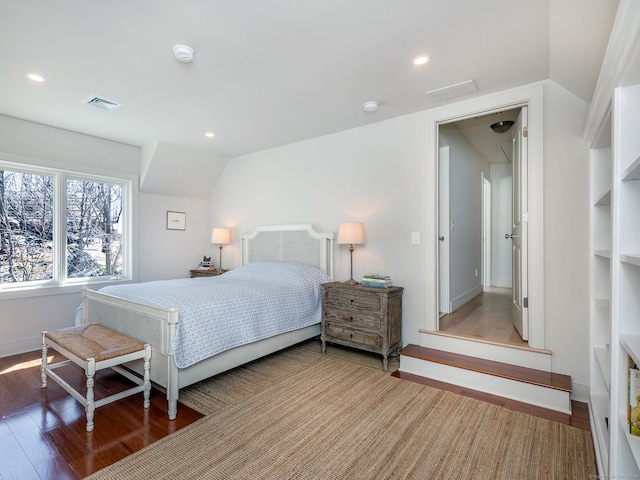 bedroom with vaulted ceiling, visible vents, recessed lighting, and wood finished floors